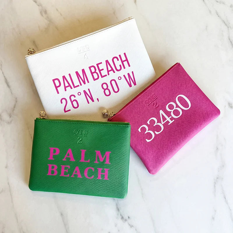 Three OTG|247 pouches, white, green, and pink, with personalization.