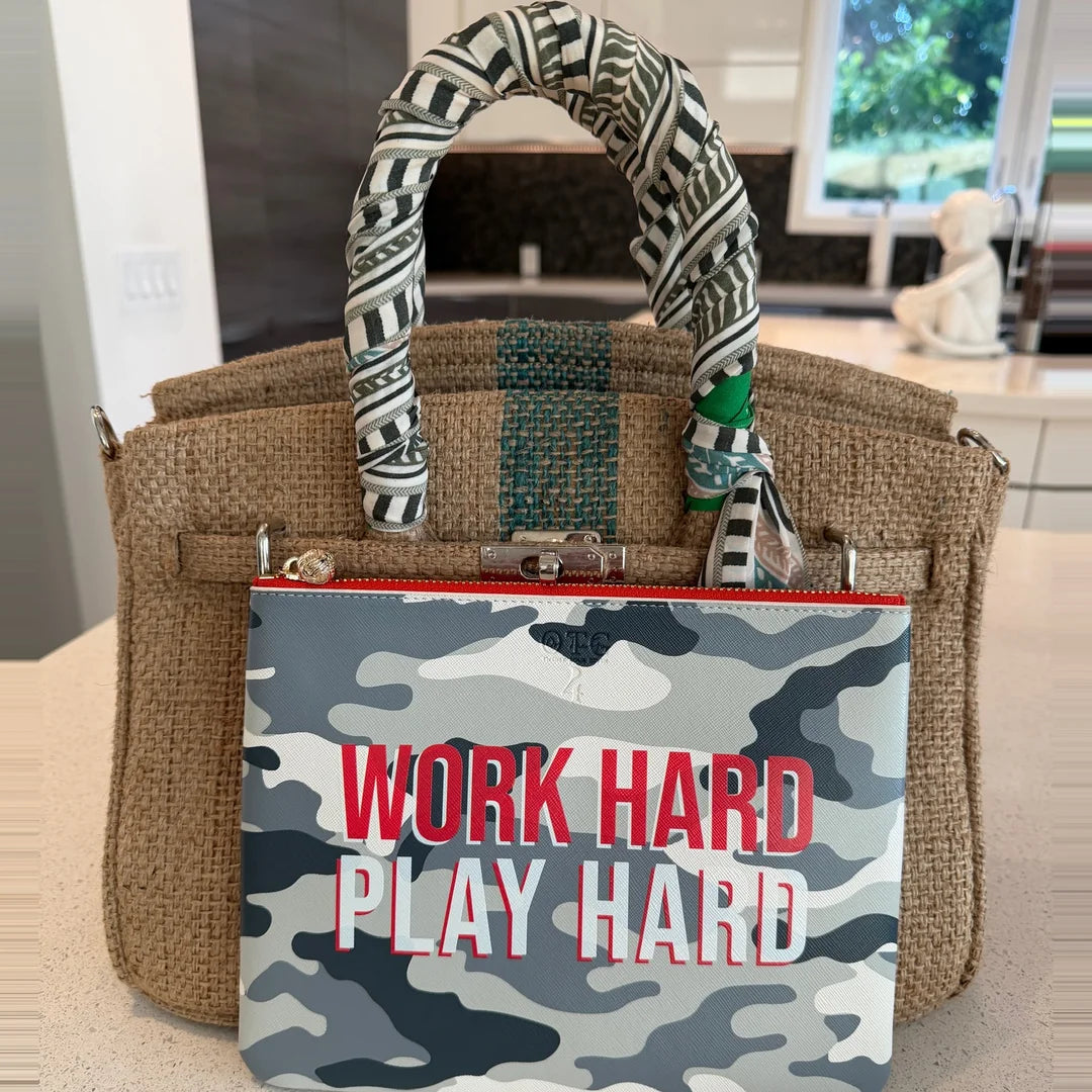 Grey camo #4 Work Hard Play Hard pouch tucked into a woven tote on a kitchen counter