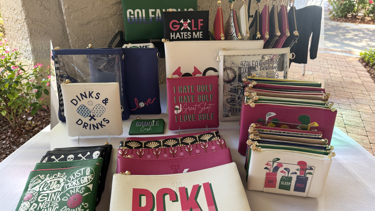 Colorful display of personalized OTG|247 pouches at a trunk show