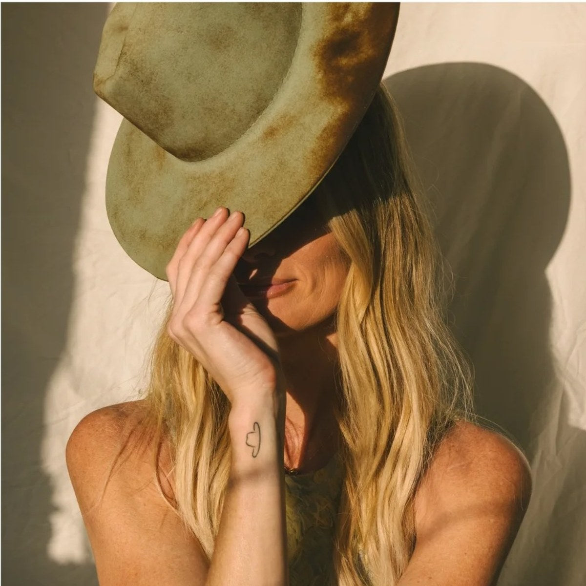 Kai Lassen tipping one of her green felt hats