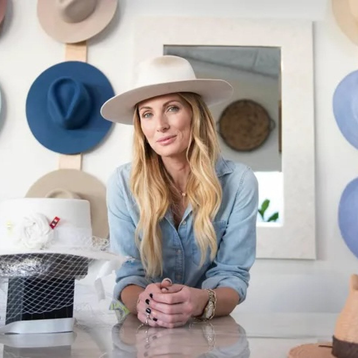 Kai Lassen in her hat shop surrounded by her hats